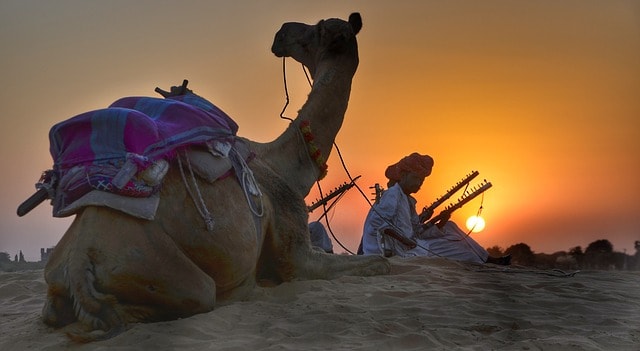 berber man with camel in desert